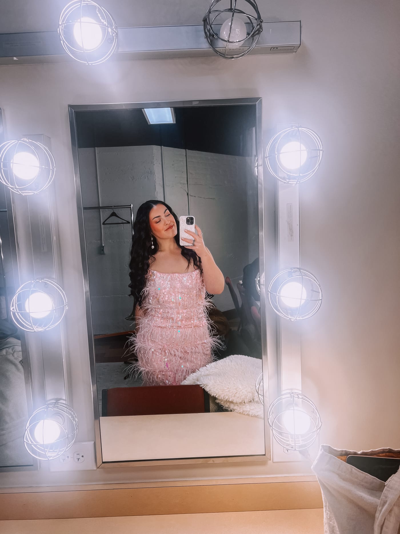 Dana in a sequinned dress in a dressing-room mirror